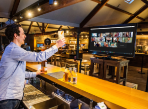 Virtual tasting host raising a toast to participants